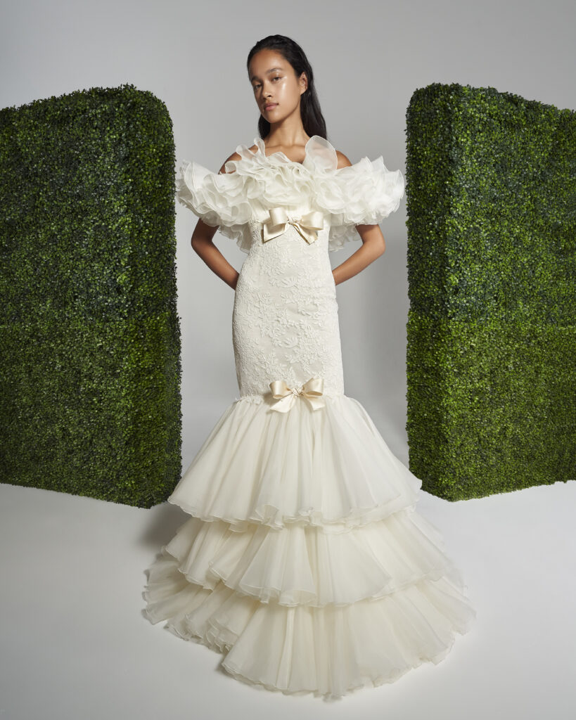 Woman posing in a Giambattista Valli white lace strapless dress